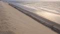 Sunset over the sea, in front of the tall sand dunes