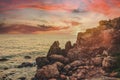 Sunset over the sea horizon and coastal cliff beach. Sea cliff on coastal beach, with a beautiful sky view Royalty Free Stock Photo