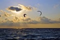 Sunset over the sea with kite surfers Royalty Free Stock Photo