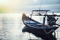 Sunset over the sea with moored traditional asian fishing boat in tranquil sea Royalty Free Stock Photo