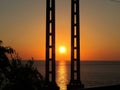 Sunset over the sea. Pillars.