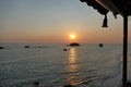 Sunset over the sea at Prasoudi, Corfu seen from the balcony of a tavern Royalty Free Stock Photo
