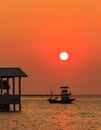Sunset Over sea , shore and fishing boat Royalty Free Stock Photo