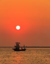 Sunset Over sea , shore and fishing boat Royalty Free Stock Photo