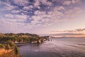 Sunset over sea shore rocks and mount Taranaki, New Zealand