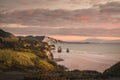 Sunset over sea shore rocks and mount Taranaki, New Zealand Royalty Free Stock Photo