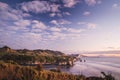 Sunset over sea shore rocks and mount Taranaki, New Zealand