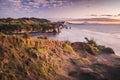 Sunset over sea shore rocks and mount Taranaki, New Zealand Royalty Free Stock Photo