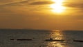 Sunset over the sea and the silhouette of a man fishing on the displacer. Pattaya, Thailand