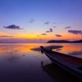 Sunset over sea with small wooden boat Royalty Free Stock Photo