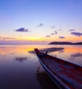 Sunset over sea with small wooden boat Royalty Free Stock Photo