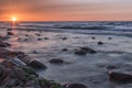 Sunset over the sea. Stone on the foreground. Royalty Free Stock Photo