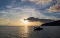 Sunset over the sea with two small boats. Royalty Free Stock Photo