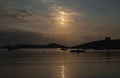 Sunset over sea water. Boats anchored at Vourkari port, Kea island, Greece