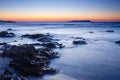 Sunset over the sea and wave washing up the beach Royalty Free Stock Photo