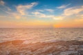 Sunset over seacoast skyline with rock on the beach Royalty Free Stock Photo