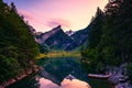 Sunset over the Seealpsee lake with small boats in the Swiss Alps, Switzerland