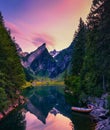 Sunset over the Seealpsee lake with small boats in the Swiss Alps, Switzerland