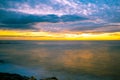 Sunset over silky smooth water with colorful reflections.