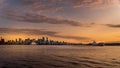 Sunset over the Skyline of Downtown Vancouver with a Ocean Freighter moored in the harbor