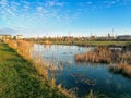 Sunset over a small lake with ducks in a park, close to apartment buildings Royalty Free Stock Photo