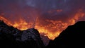 Sunset over snow-capped mountains in the Himalayas near Sherpa village Thame, Nepal with dramatic orange and purple colored sky. Royalty Free Stock Photo