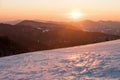 Sunset over snow covered mountains Royalty Free Stock Photo