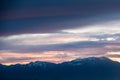 Sunset over the snow covered mountains Royalty Free Stock Photo