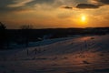 Sunset over snow-covered rolling hills and farm fields in Carroll County, Maryland. Royalty Free Stock Photo