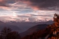 Snowed mountains, with colorful glowing clouds.