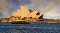 Sunset over Sydney Opera House from Sydney Harbour with ferry in foreground Royalty Free Stock Photo