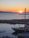 Sunset over Tinos island Cyclades Greece. Ship mast, port, golden sun colors sky and sea. Vertical Royalty Free Stock Photo