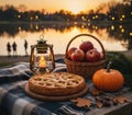 Sunset over a tranquil lake creates a warm backdrop for a picnic setting. Royalty Free Stock Photo