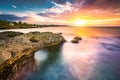 Sunset over a tropical rocky beach Royalty Free Stock Photo