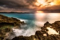 Sunset over a tropical rocky beach Royalty Free Stock Photo