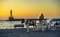 Sunset over The Venetian era harbour and lighthouse at the Mediterranean port of Chania, Crete, Greek Islands, Greece Royalty Free Stock Photo