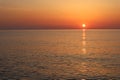 Sunset over the sea, water and sky and orange sun Royalty Free Stock Photo