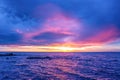 Sunset over water in lilac blue tones