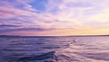 Sunset over water, tranquil scene, reflecting beauty generated by AI