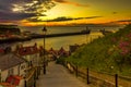 Sunset over Whitby harbour with an incoming tide Royalty Free Stock Photo