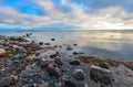 Sunset over the White Sea, stones, reflection. Royalty Free Stock Photo