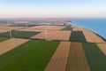 Sunset over the windmills. Wind turbines over fields of wheat and sunflowers Royalty Free Stock Photo