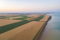 Sunset over the windmills. Wind turbines over fields of wheat and sunflowers Royalty Free Stock Photo