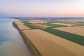 Sunset over the windmills. Wind turbines over fields of wheat and sunflowers Royalty Free Stock Photo