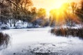 Sunset over winter forest lake Royalty Free Stock Photo