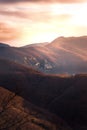 Sunset over wooded and rocky terrains