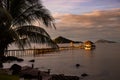 Sunset over wooden beach bar in sea and hut on pier in koh Mak island, Trat, Thailand Royalty Free Stock Photo