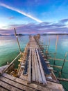 Sunset over wooden beach bar in sea and hut on pier in koh Mak island, Trat, Thailand Royalty Free Stock Photo