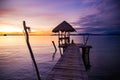 Sunset over wooden beach bar in sea and hut on pier in koh Mak island, Trat, Thailand Royalty Free Stock Photo