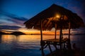 Sunset over wooden beach bar in sea and hut on pier in koh Mak island, Trat, Thailand Royalty Free Stock Photo